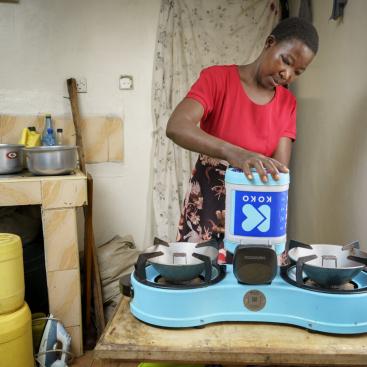 A-KOKO-customer-in-Nairobi-adding-fuel-to-her-KOKO-Cooker-at-home